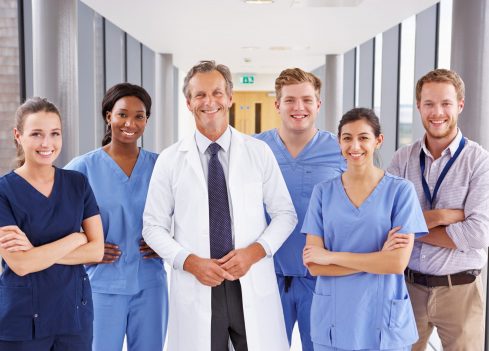 Portrait Of Medical Team Standing In Hospital Corridor